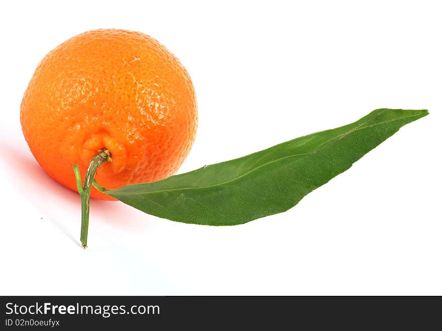 Tangerine with green leaves and water drops isolated on white