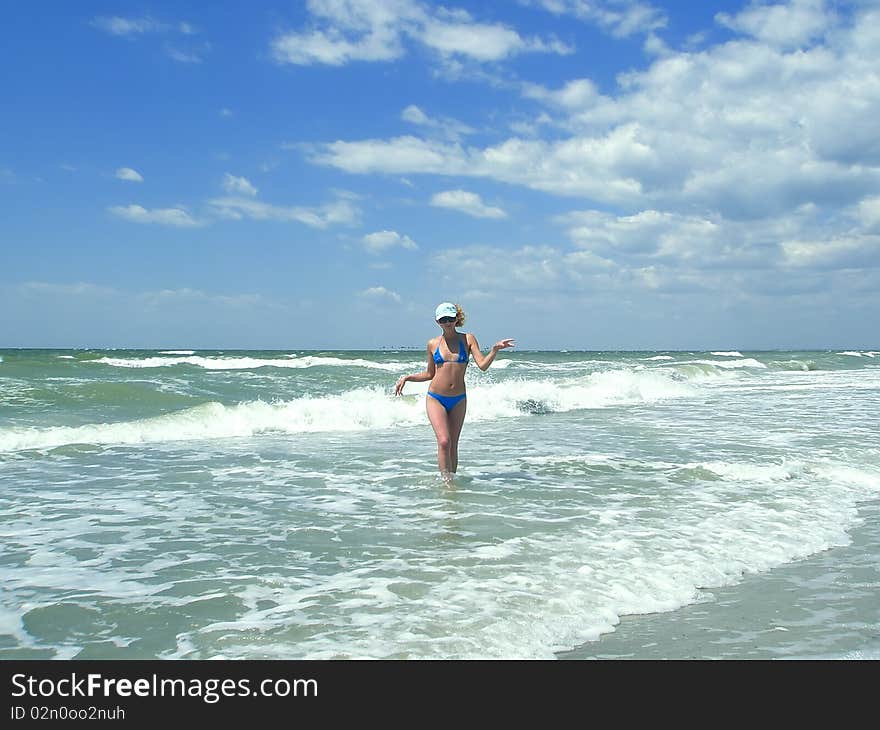 Woman goes from the sea. Kinburn Spit, near Ochakiv, Ukraine