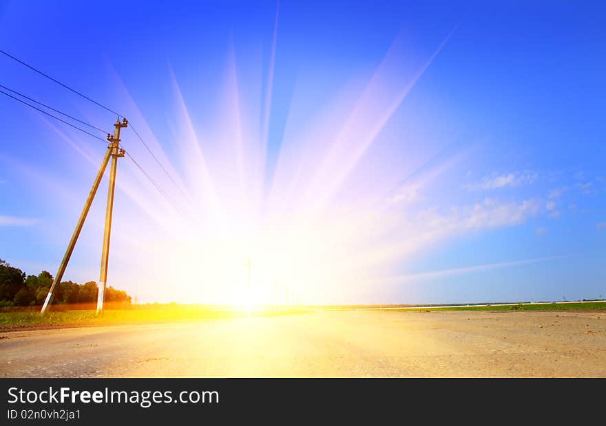 Sunset and the road. Summer field