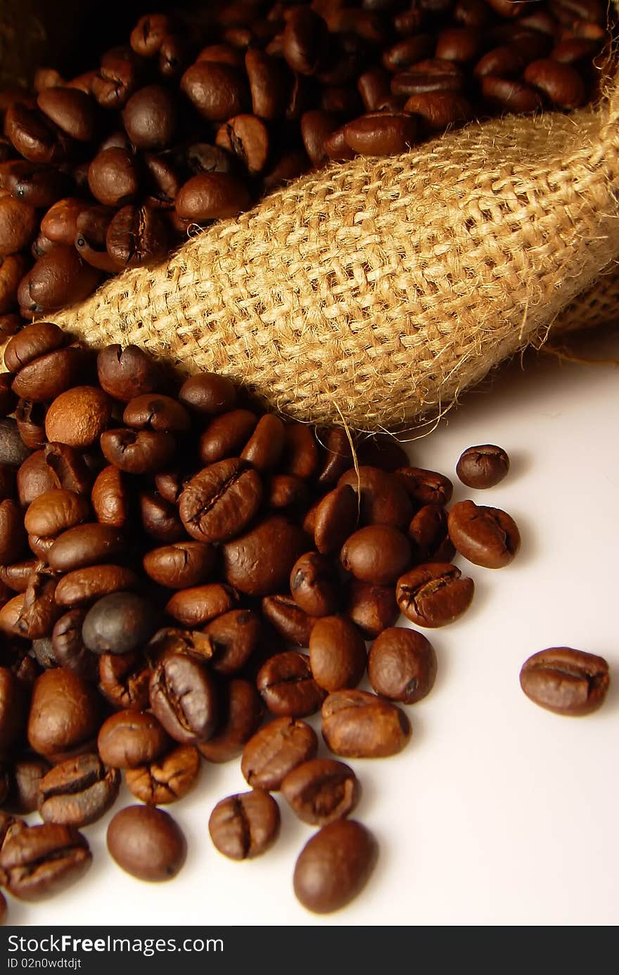 Roasted Coffee beans with coffee bag on white background