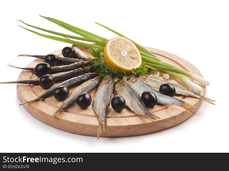 A composition with smoked clupea herring fish (Clupea harengus membras) on wooden plate isolated on white. A composition with smoked clupea herring fish (Clupea harengus membras) on wooden plate isolated on white