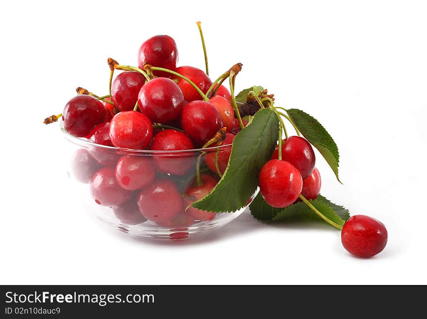 Berries are sweet cherries in a glass vase on a white background. Berries are sweet cherries in a glass vase on a white background