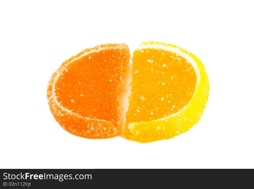 Slices of orange and lemon marmalade on a white background. Slices of orange and lemon marmalade on a white background