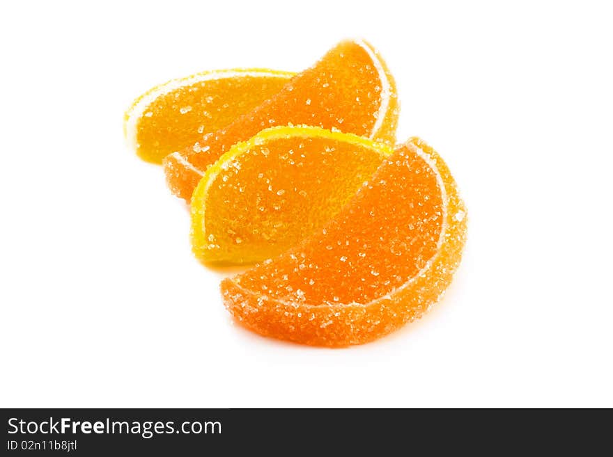 Slices of orange and lemon marmalade on a white background. Slices of orange and lemon marmalade on a white background