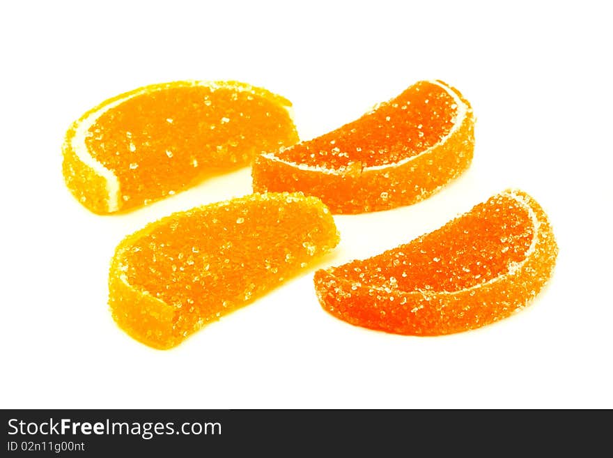 Slices of orange and lemon marmalade on a white background. Slices of orange and lemon marmalade on a white background