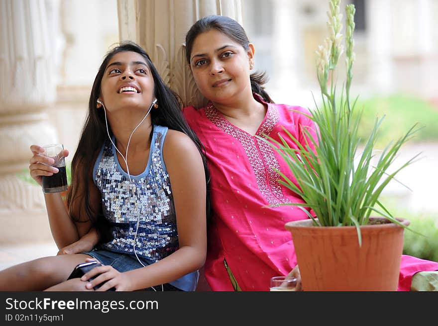 Happy mother and daughter listening music. Happy mother and daughter listening music