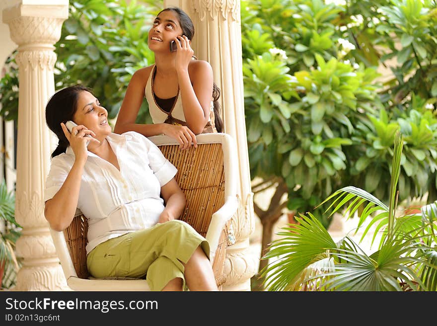 Mother and daughter busy in talking. Mother and daughter busy in talking