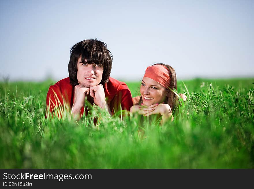 Boy and smiling girl in kerchief on grass. Boy and smiling girl in kerchief on grass