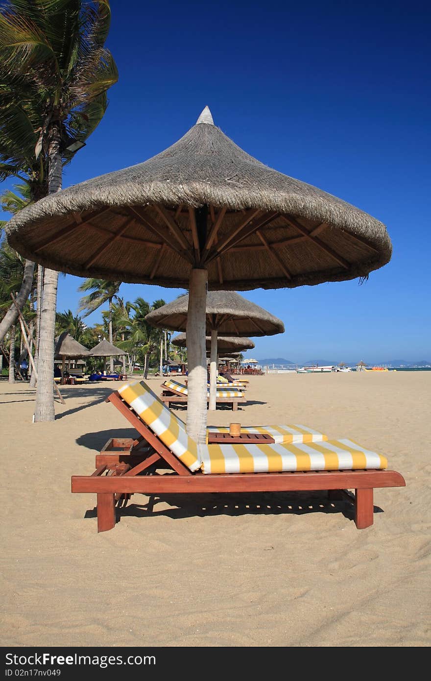 chairs and umbrella on tropical beach.SanYa.china. chairs and umbrella on tropical beach.SanYa.china