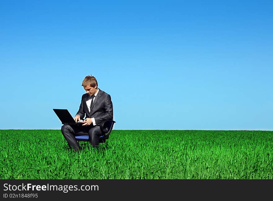 Successful man on the field with laptop. Successful man on the field with laptop