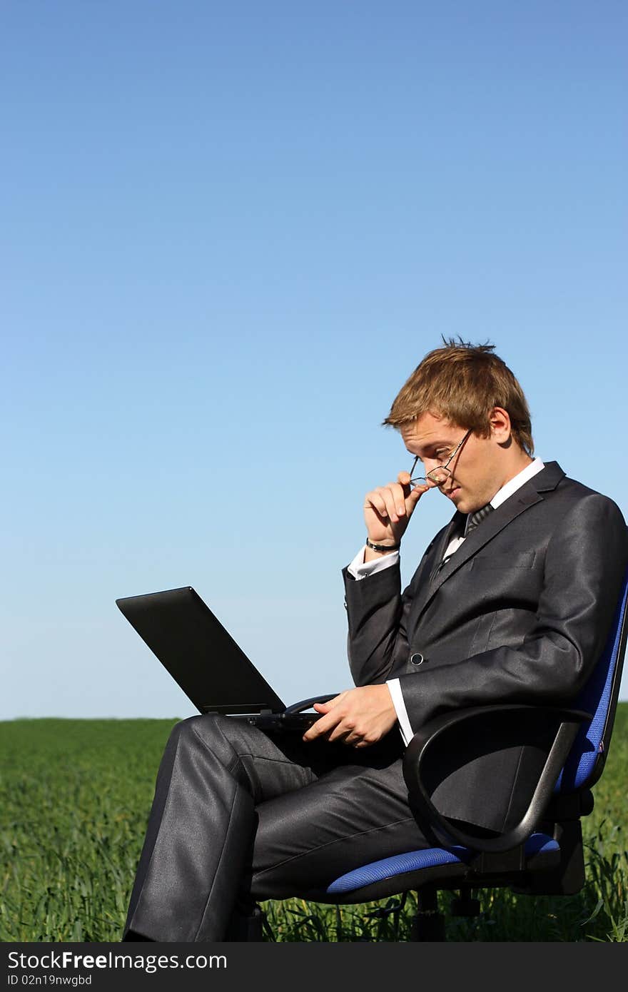 Happy businessman on the field. With laptop. Happy businessman on the field. With laptop