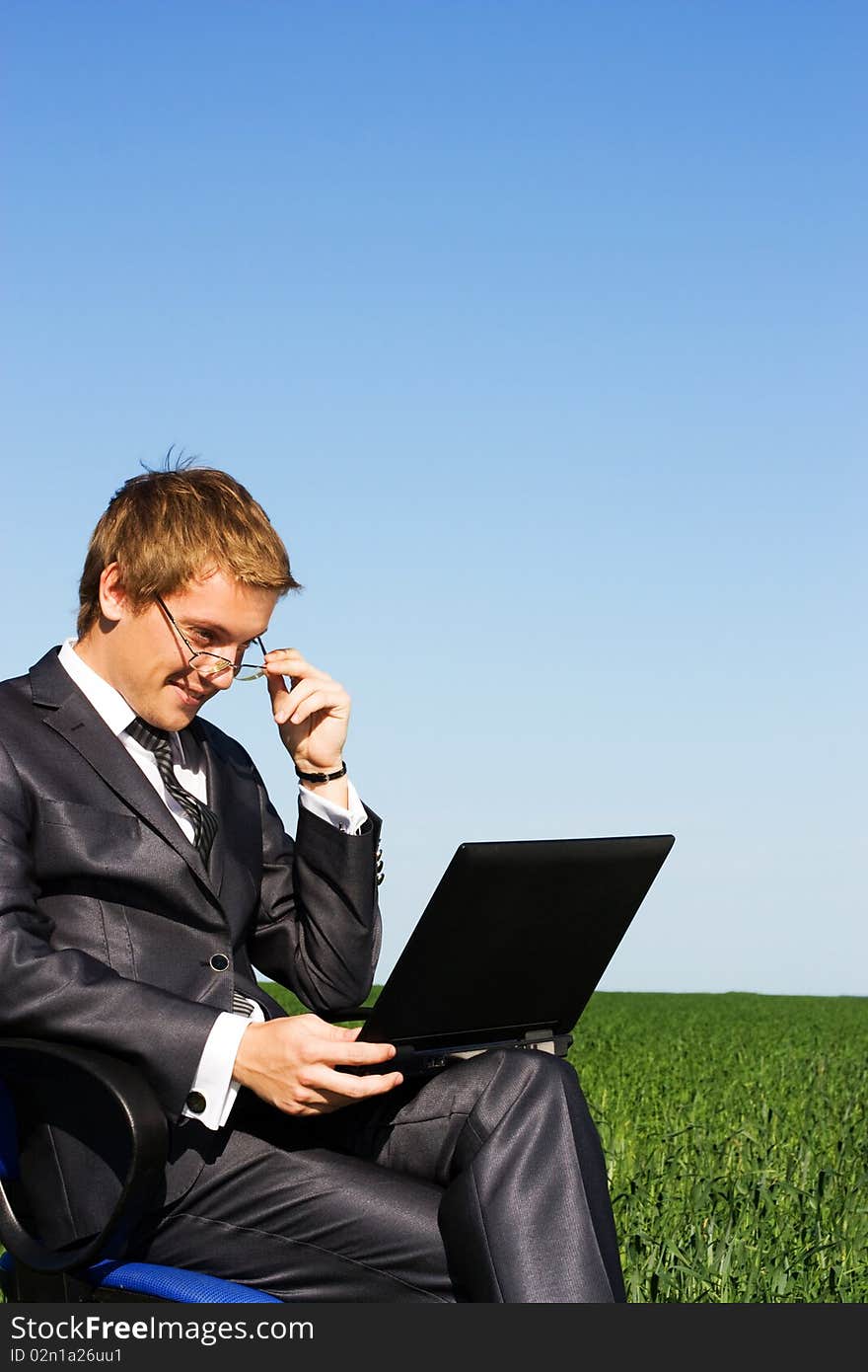 Successful businessman in the field, with glasses. Successful businessman in the field, with glasses