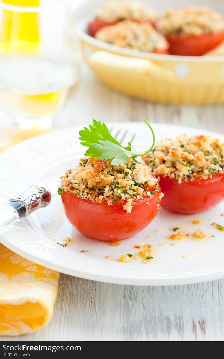 Provencal style baked tomatoes on the plate. Provencal style baked tomatoes on the plate