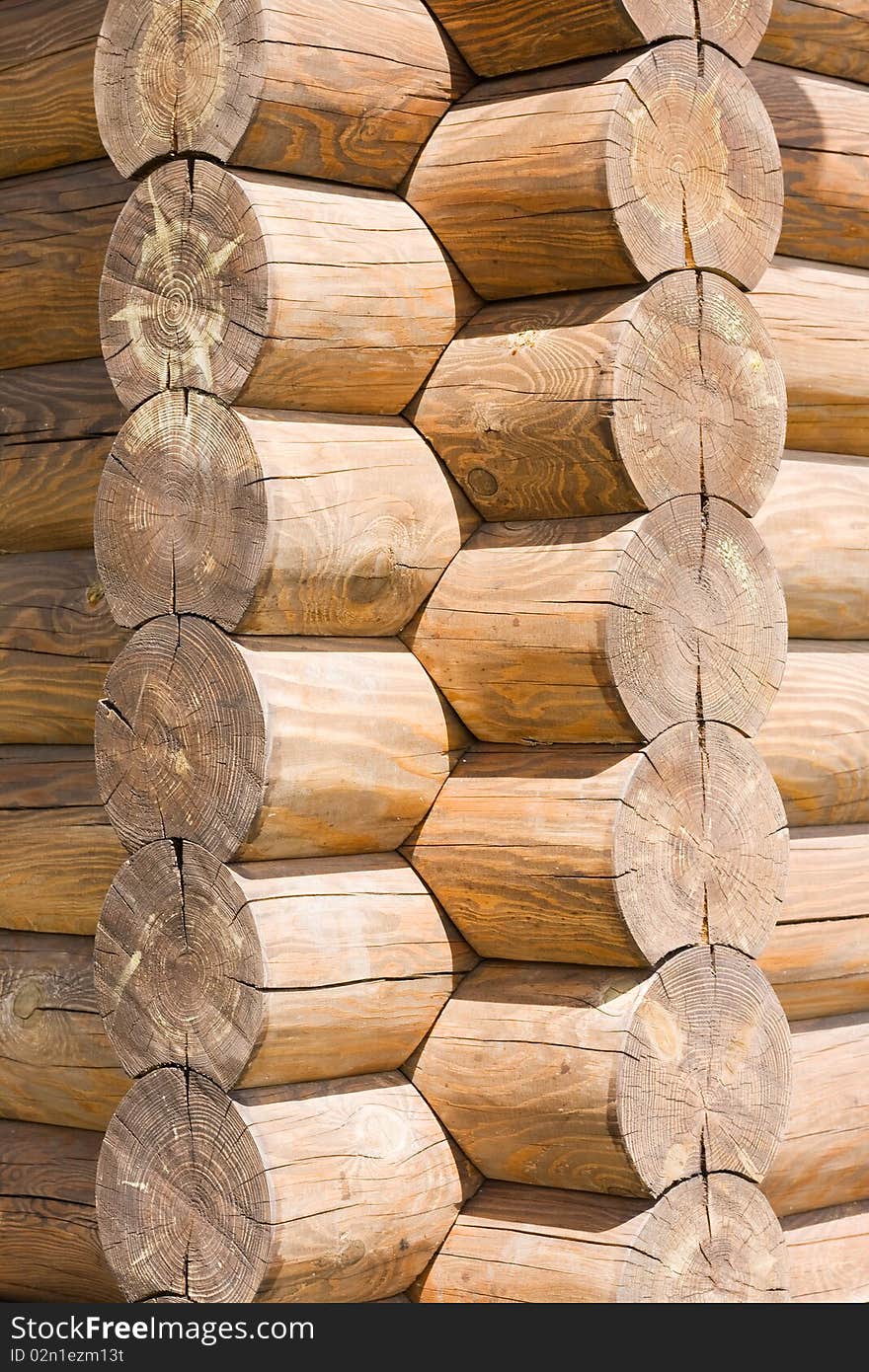 Corner of wooden log cabin of light brown color