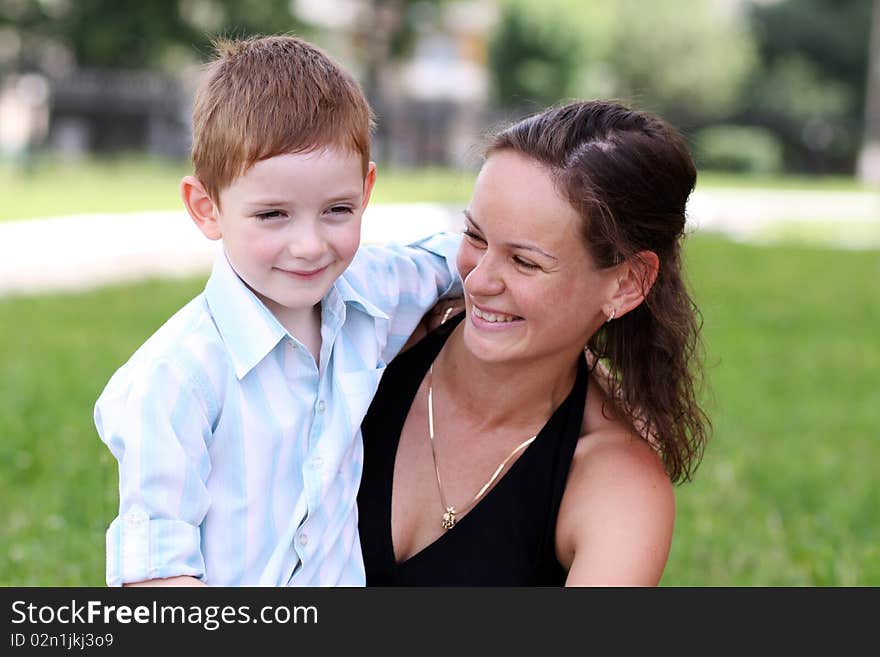 Happy mother and her little son outdoors session