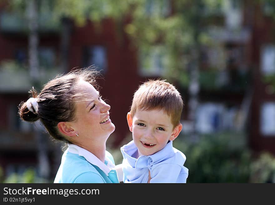 Happy mother and her little son outdoors session