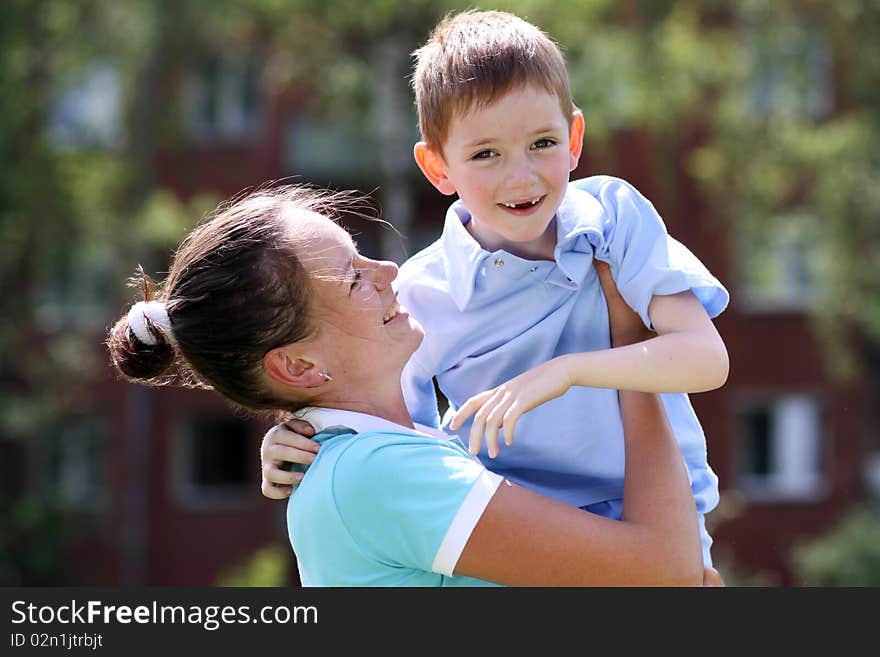 Happy mother and her little son outdoors session