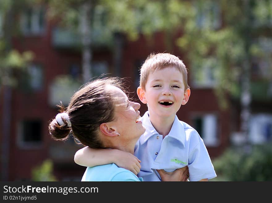 Happy mother and her little son outdoors session