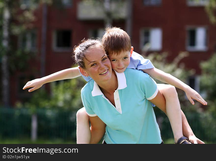 Happy mother and her little son outdoors session