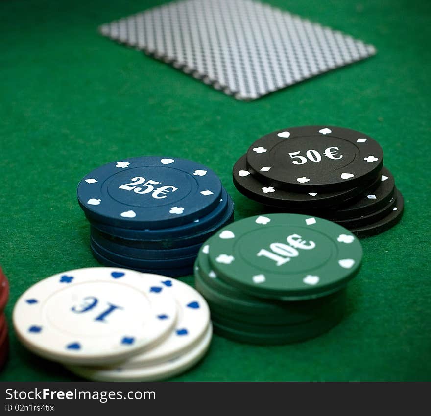 Cards and poker chips on a green  background