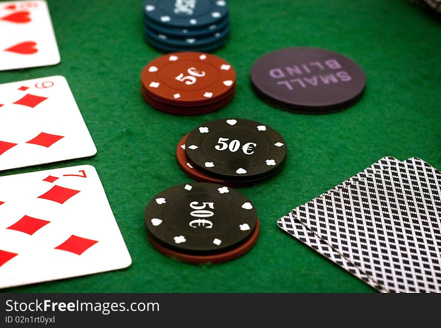 Cards and poker chips on a green  background