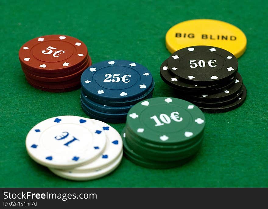 Cards and poker chips on a green  background