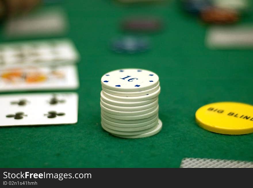 Cards and poker chips on a green  background