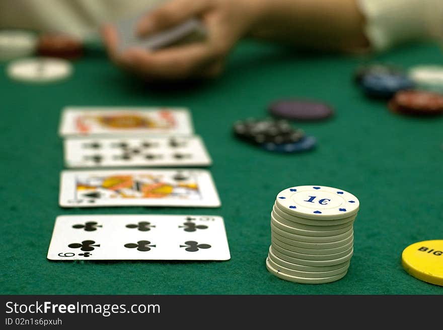 Cards and poker chips on a green  background