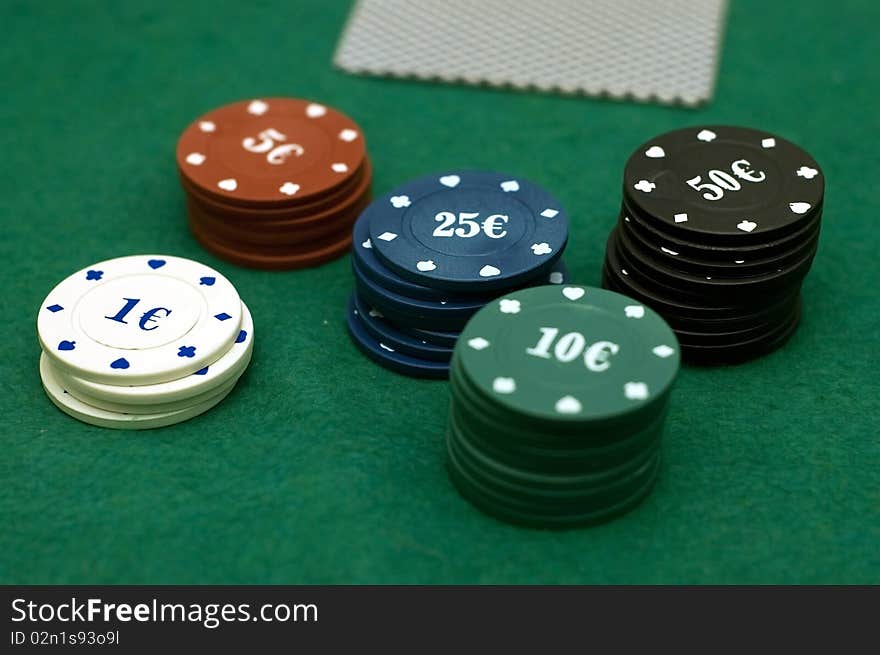 Cards and poker chips on a green background