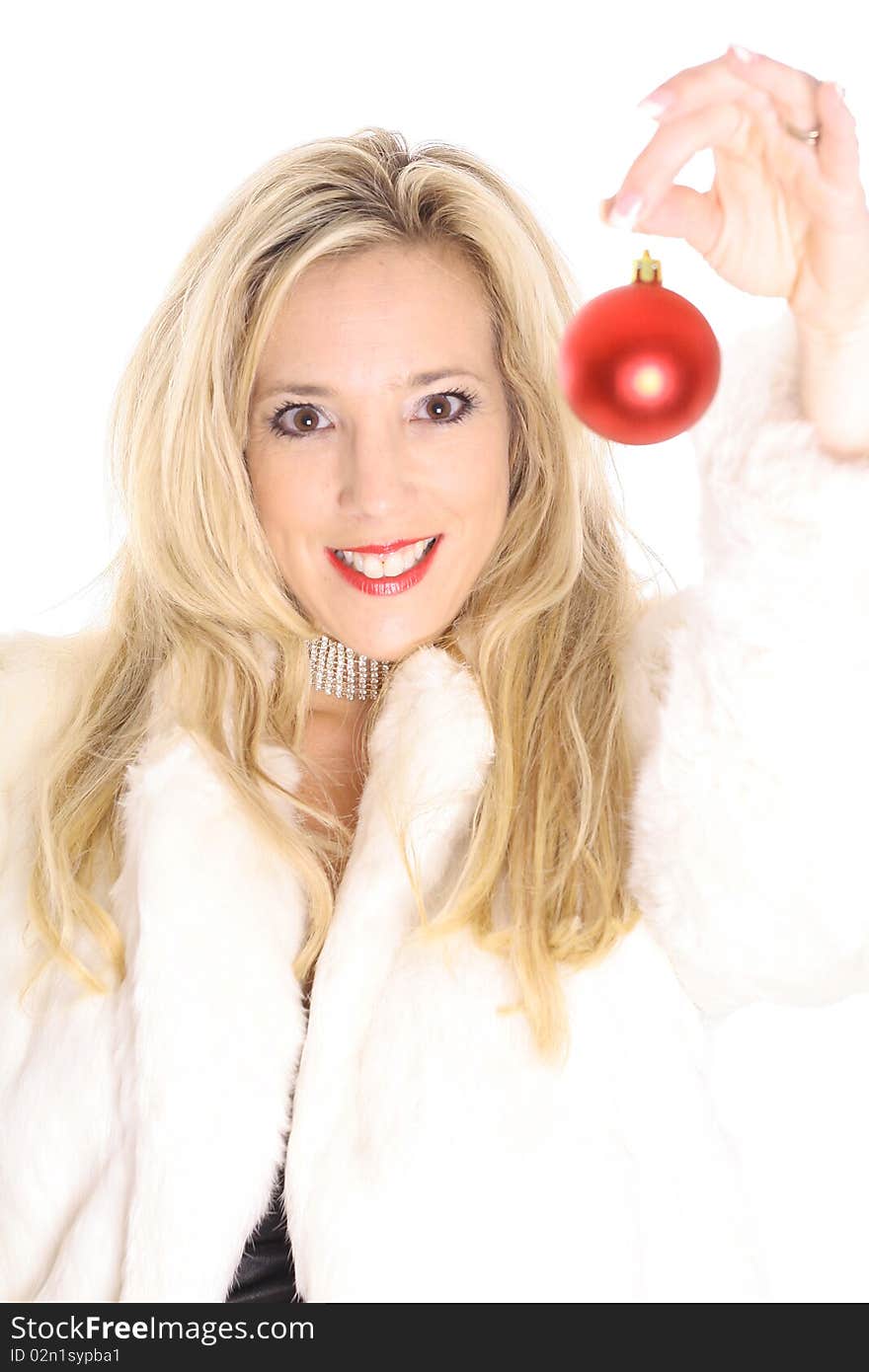 Shot of a Gorgeous blonde in fur holding an christmas ornament upclose