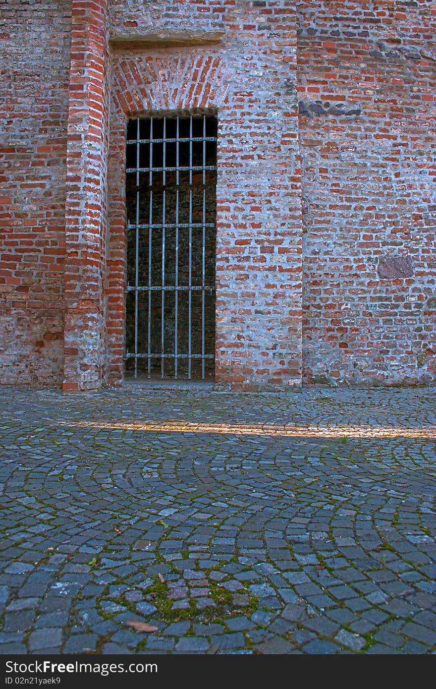 Old barred castle side entrance. Old barred castle side entrance