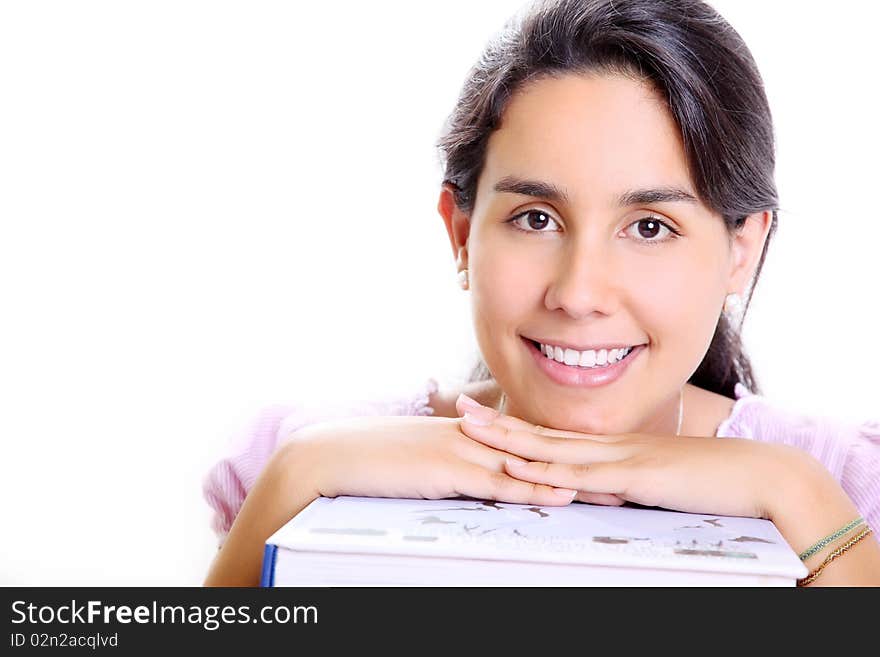 Smiling young girl's face on several books. Smiling young girl's face on several books