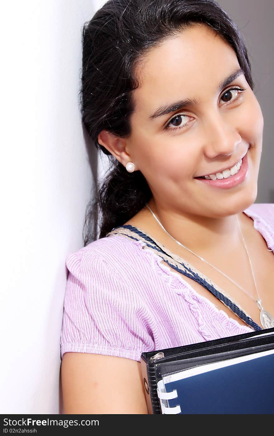 Student looking at the camera with books. Student looking at the camera with books