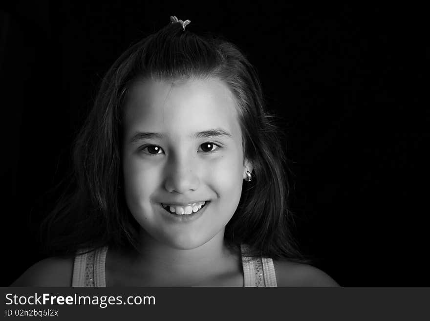 Girl smiling and looking at the camera. Black and white image