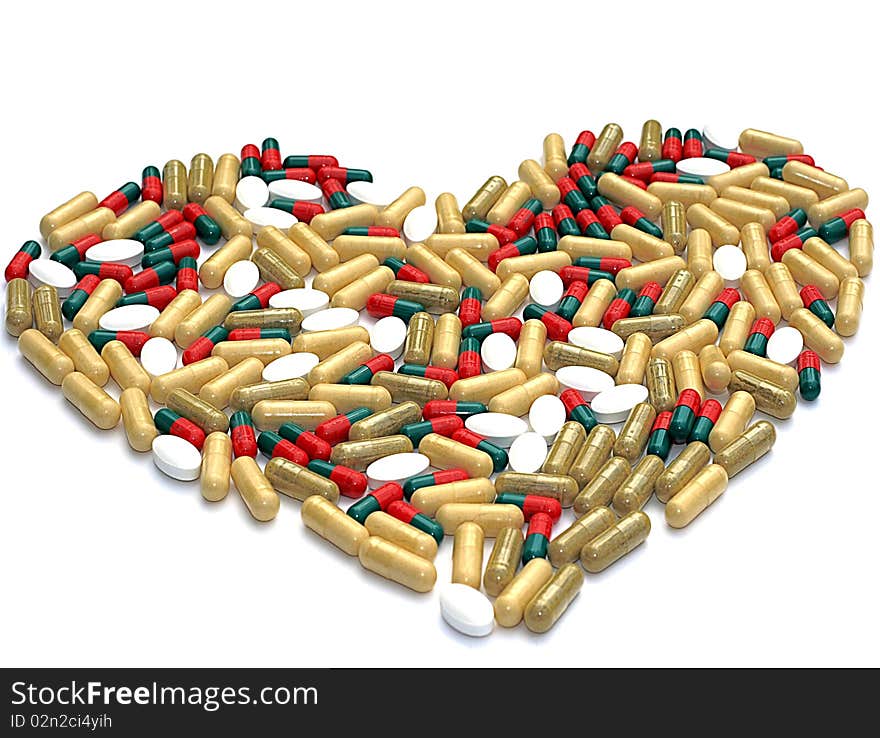 Heart shaped out of pills, isolated on white. Heart shaped out of pills, isolated on white