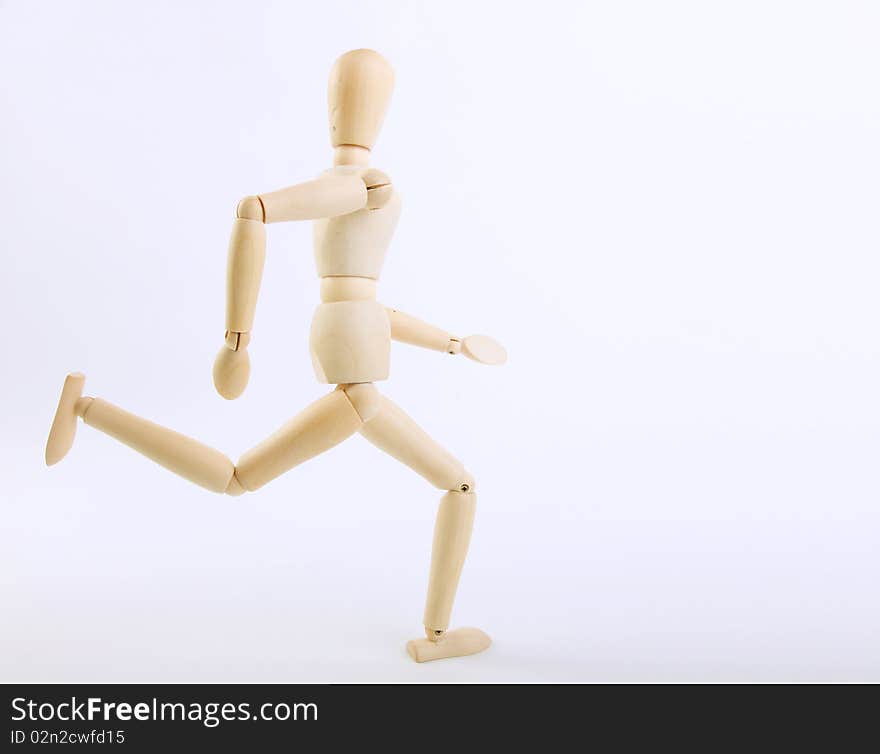 Wooden doll running on a white background.