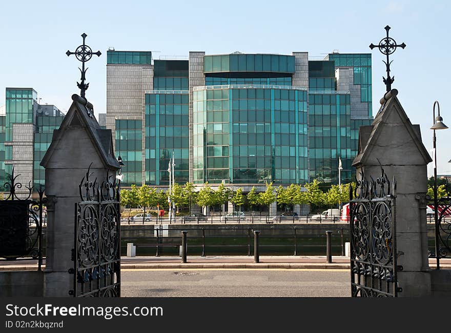 Dublin old and new - modern glass financial building framed by old Christian crosses. Dublin old and new - modern glass financial building framed by old Christian crosses.