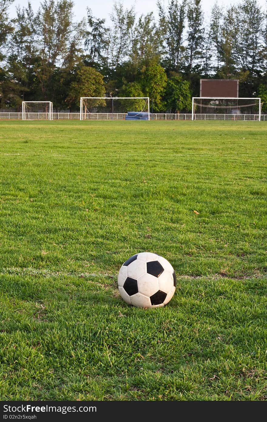 One football on the ground and three. One football on the ground and three