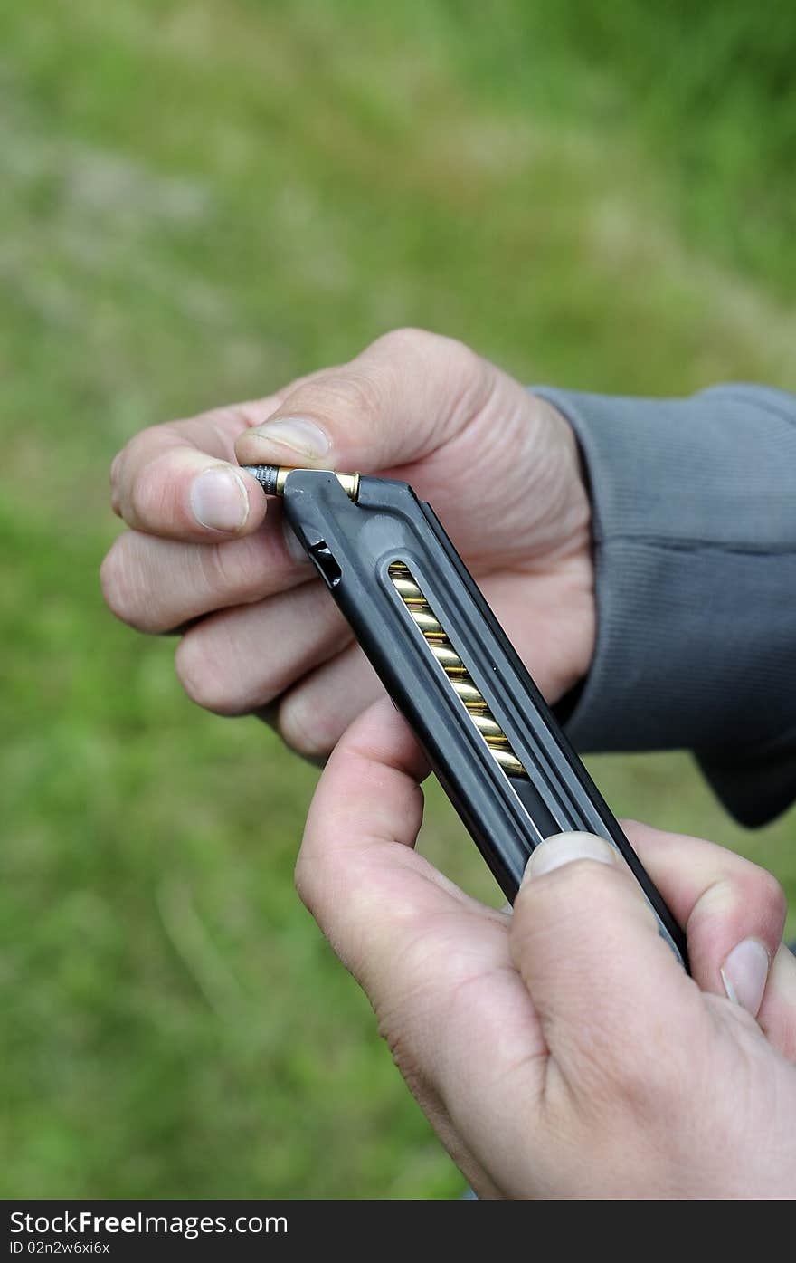 Loading a bunch of bullets into a handgun magazine. Loading a bunch of bullets into a handgun magazine.