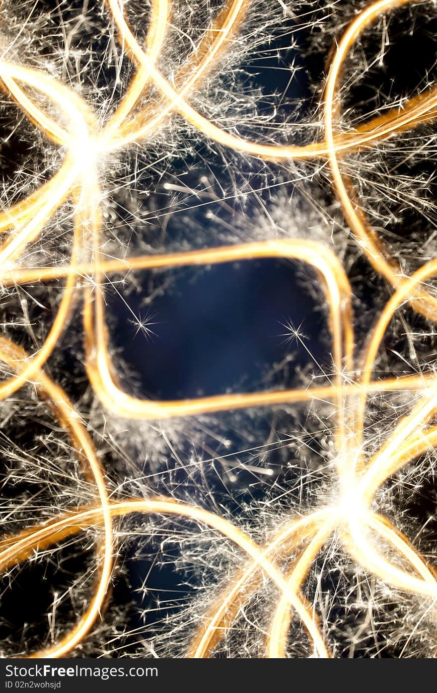 A bunch of glowing abstract sparkler background image with copyspace in the middle. Some sparks are in focus, but most are intentionally slightly out of focus. A bunch of glowing abstract sparkler background image with copyspace in the middle. Some sparks are in focus, but most are intentionally slightly out of focus.