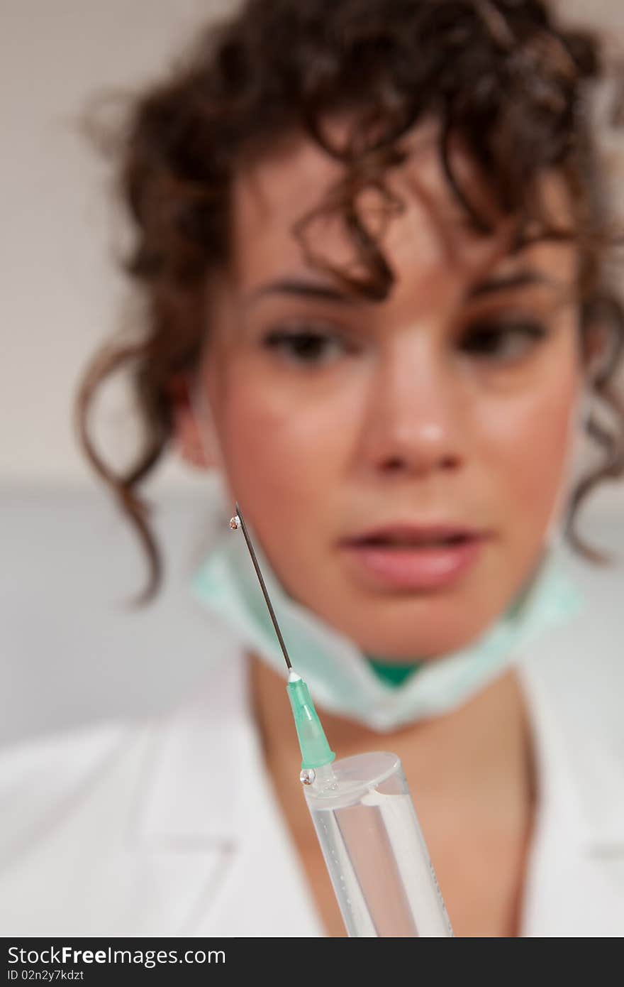 Young female doctor holding a needle shot