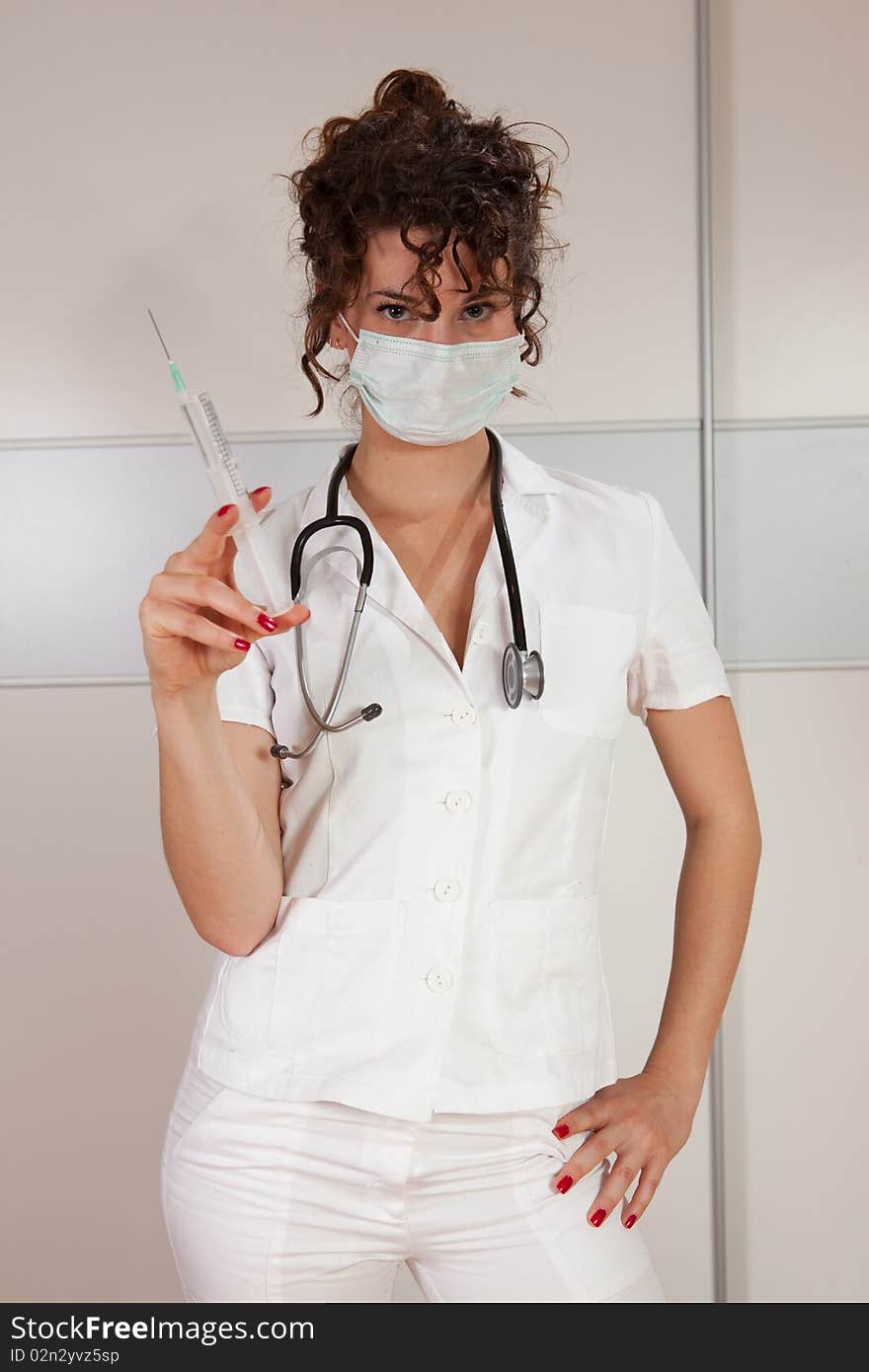 Young female doctor holding a needle shot