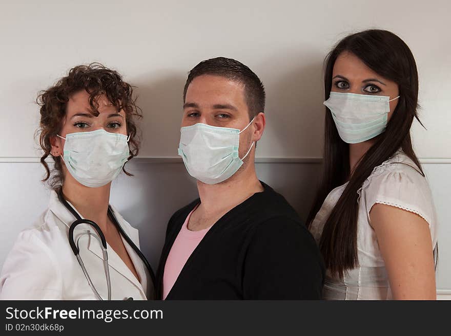 Group of three young people wearing surgical masks. Group of three young people wearing surgical masks