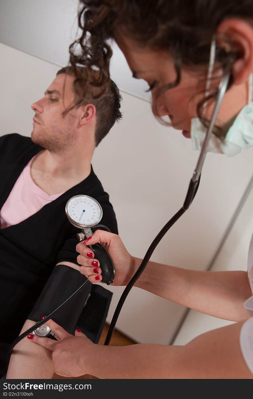 Young female doctor measuring blood pressure. Young female doctor measuring blood pressure