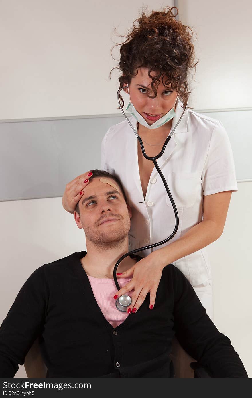 Young female doctor taking care about her patient. Young female doctor taking care about her patient