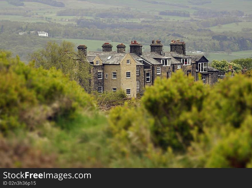 English countryside landscape: house behind bushes