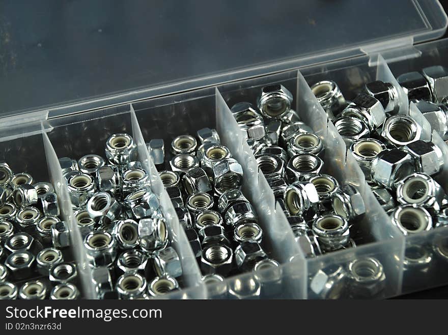 Box containing several nuts and washers of different sizes. Box containing several nuts and washers of different sizes