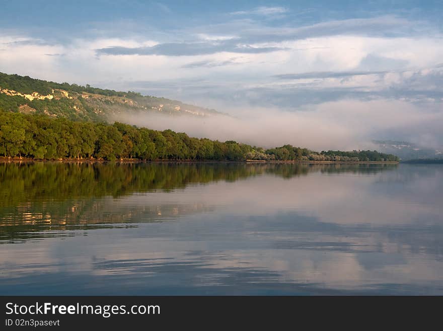 In a river landscape with nature morning with fog