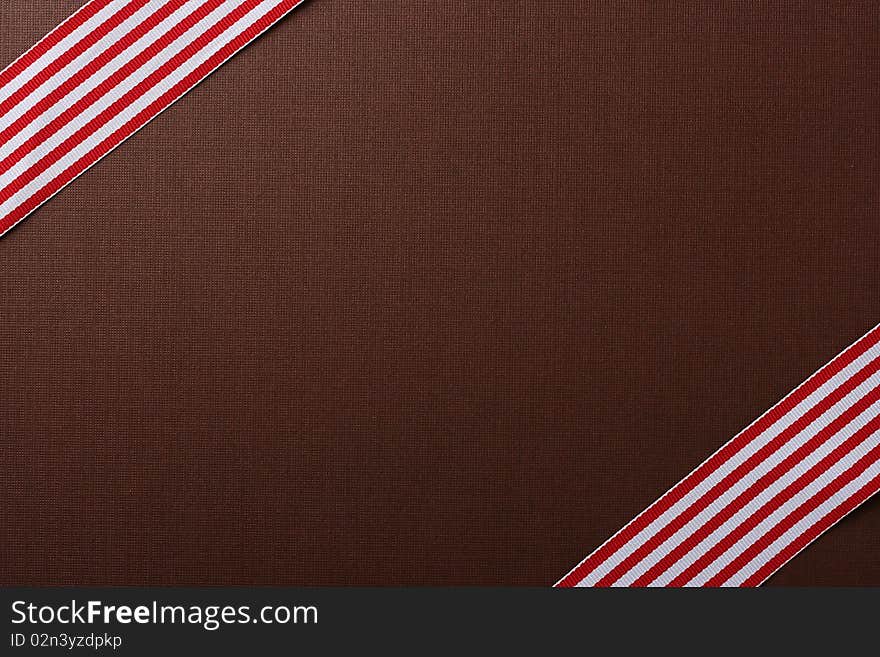 Brown background with two red-white tapes for design works.