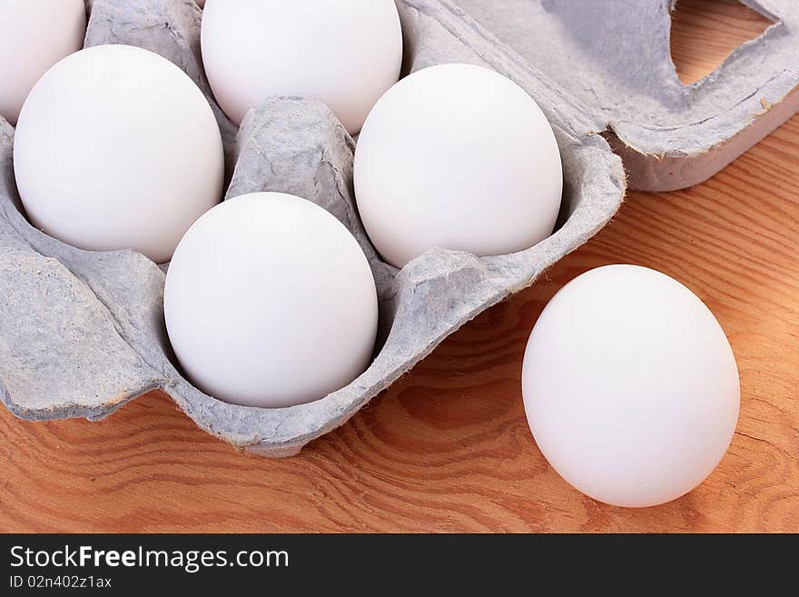 Eggs of white colour are combined in a special tray for transportation and sale.